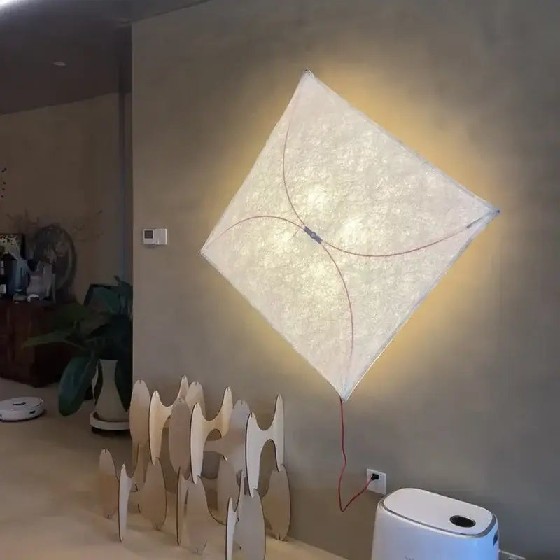A decorbites led square fabric wall lamp with a diamond shape textured off-white diffuser and curved wire accents