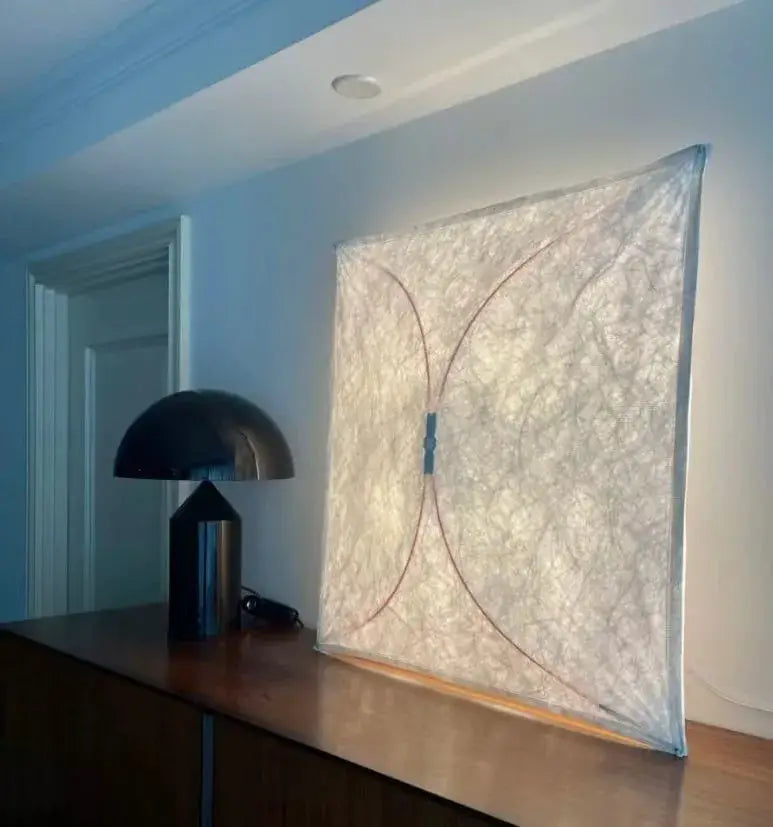 A decorbites led square fabric wall lamp with a textured off-white surface and subtle curved lines for modern interiors