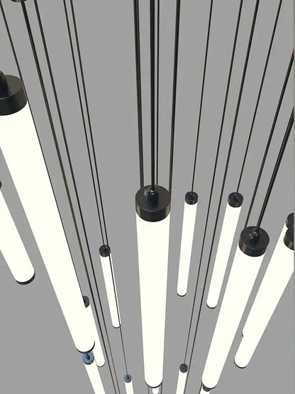 Modern minimalist staircase chandelier by DecorBites featuring sleek black cylindrical led fixtures with glowing white tubes