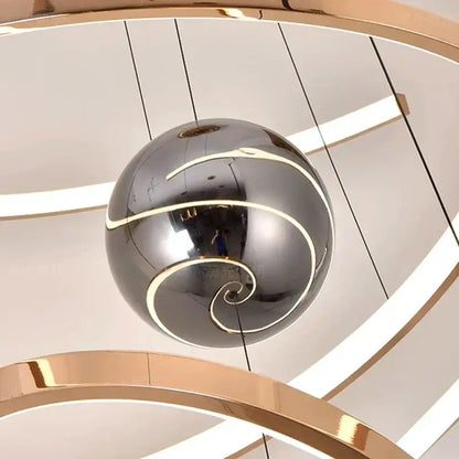 A sleek chrome pendant light with gold spiral accents from decorbites led staircase chandelier collection for indoor use