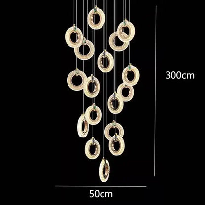 Gold-toned decorbites led staircase chandelier with embedded led lights and crystal accents in cascading design for modern living rooms