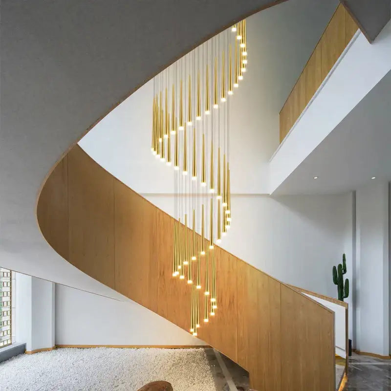 Decorbites led staircase chandelier featuring a golden spiral design with slender vertical rods emitting warm light for luxury interiors
