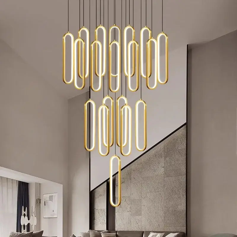Modern gold-toned oval pendant lights with glowing led lighting by DecorBites led staircase chandeliers for living room
