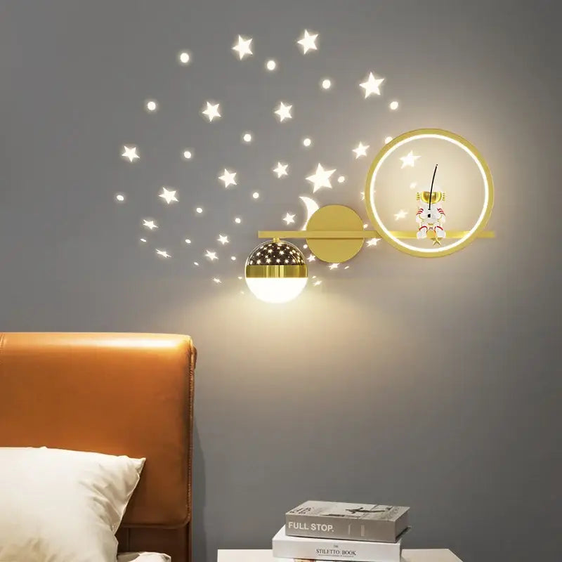 Gold-toned DecorBites led star wall sconce with spherical globe and crescent moon for modern children’s bedroom decor