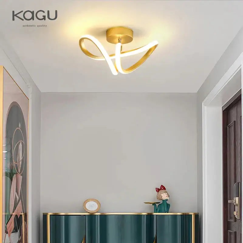 Gold-colored DecorBites™ led surface mounted ceiling lights with sleek curved arms emitting warm glow for home lighting