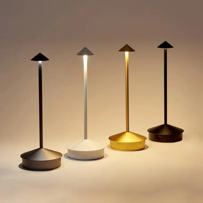 Four minimalist DecorBites™ led table lamps with tapered metal stems in black white gold and dark bronze finishes