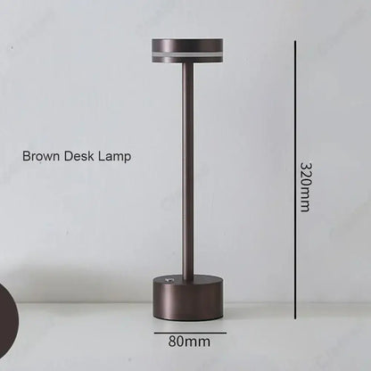 A sleek minimalist brown decorbites led touch table lamp with cylindrical base and three-tone rechargeable lighting