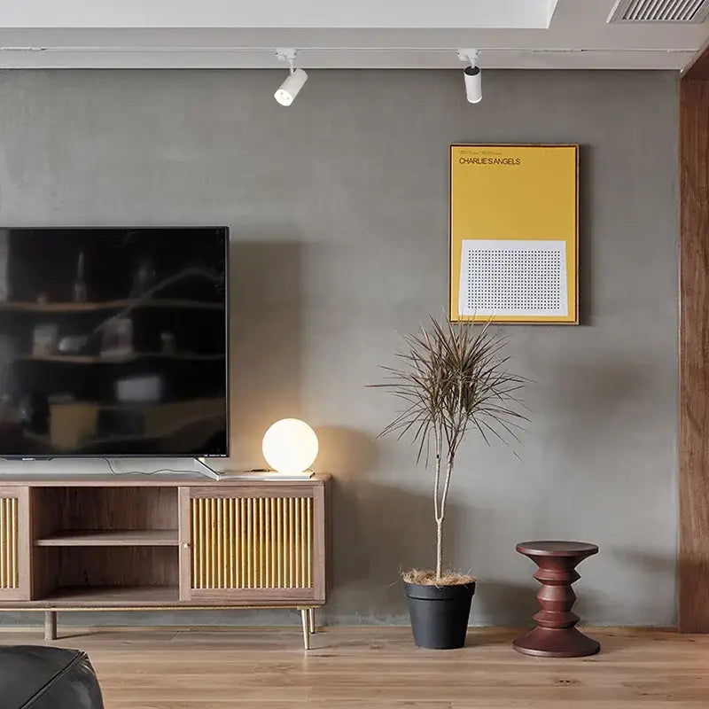 A sleek wooden tv console under a decorbites led track 7w cob rail spotlight for art exhibition and picture show