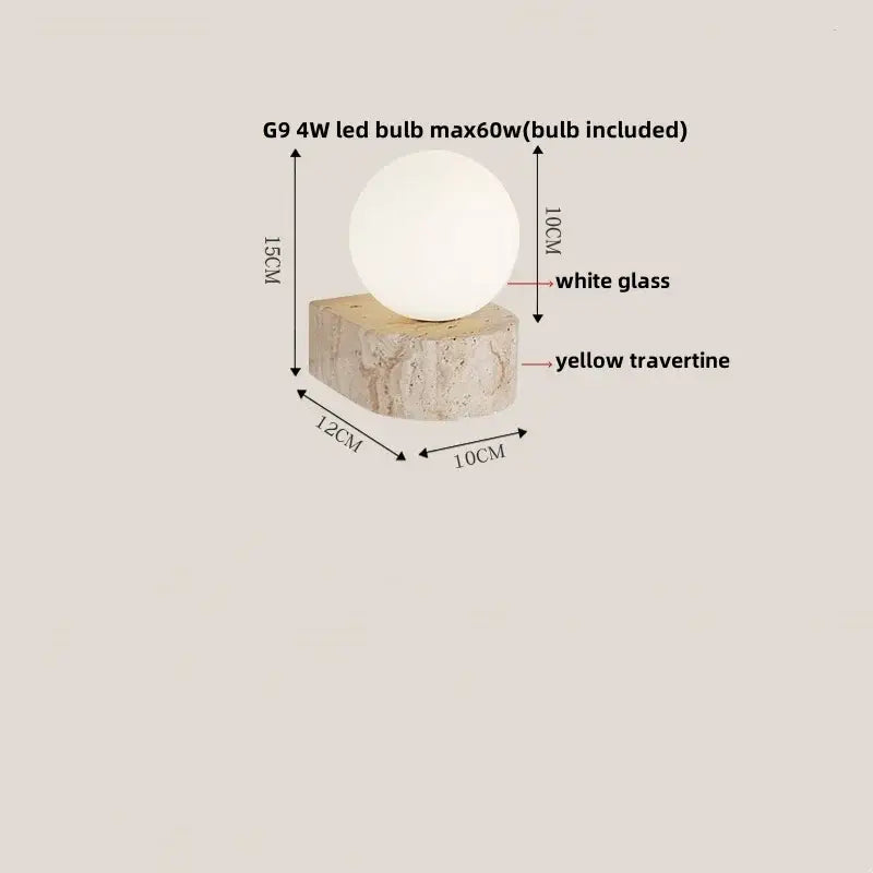 A modern decorbites led travertine wall light with a smooth white glass globe and textured yellow travertine base
