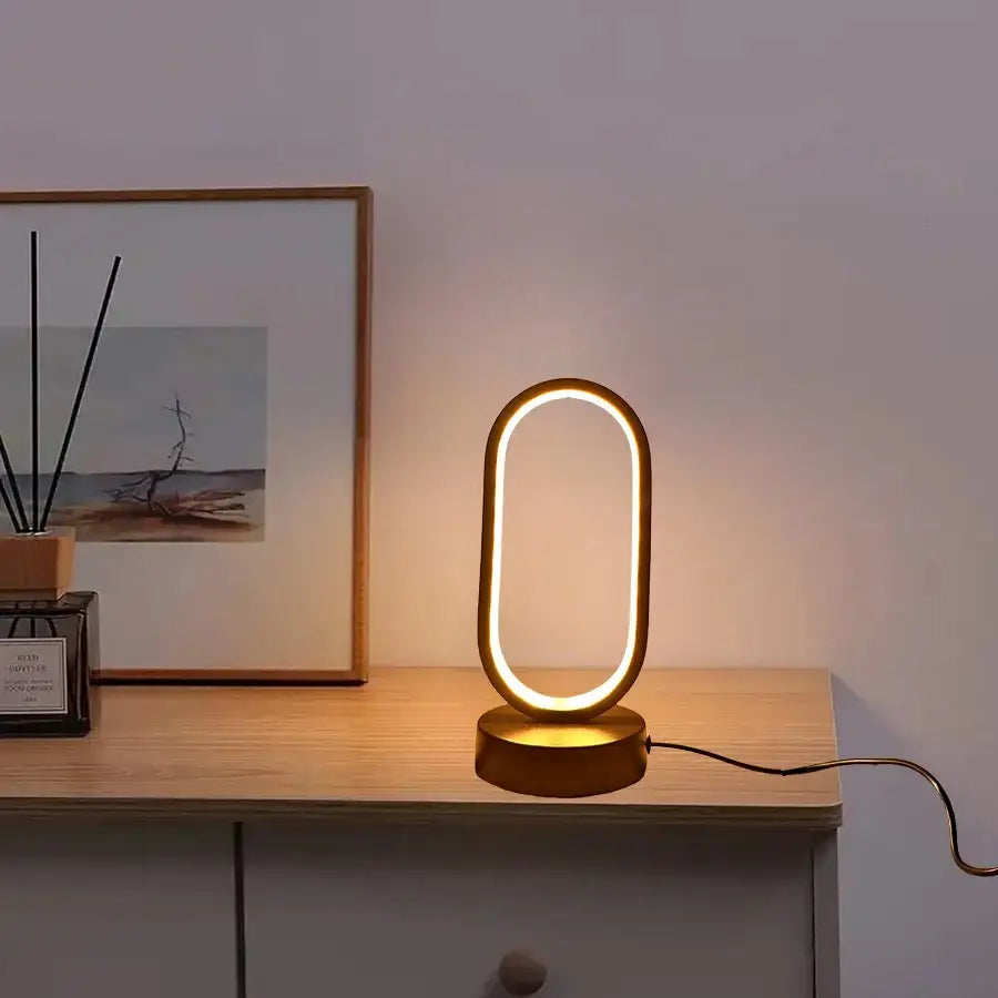 Gold-toned oval led table lamp bedroom bedside decorative lamp with sleek modern design and warm ambient lighting