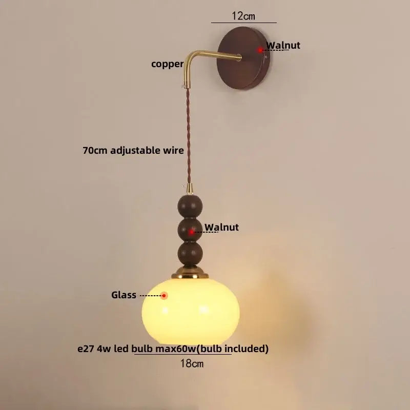 Warm-toned orange glass decorbites led wall pendant light with copper hardware and walnut beads for bedroom decor
