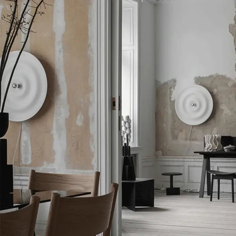 Decorbites led white sconce with ripple design featuring white concentric rings and a central metallic fixture for living room