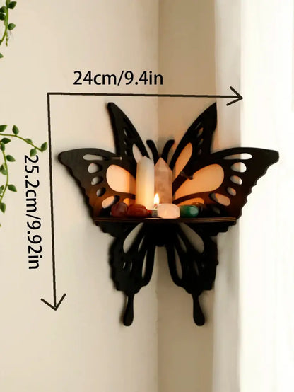 Black butterfly-shaped decorbites™ lotus floating wall shelf with cutout wings holding candles and stones on platform
