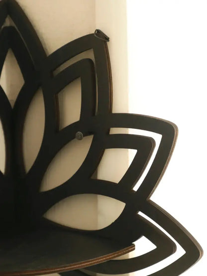 Black wooden lotus floating wall shelf with layered petal design and flat bottom surface by DecorBites™