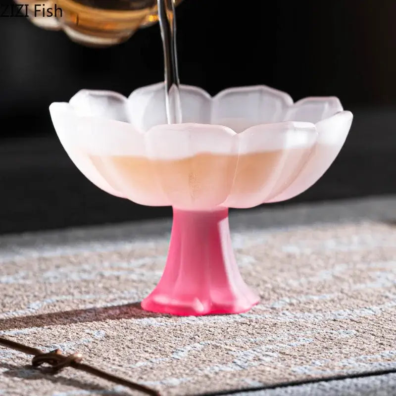 A translucent pink and white lotus flower glass tea pitcher with a fluted bowl and pedestal base by DecorBites lotus flower