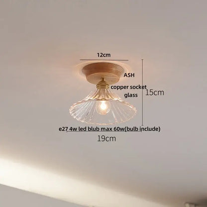 A warm-toned decorbites lotus glass led ceiling light with clear fluted glass shade and copper base in modern nordic design