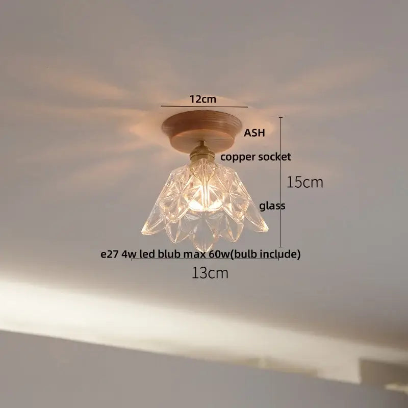 Decorbites lotus glass led ceiling light with a clear faceted glass pendant, copper socket, and wooden base in modern nordic design