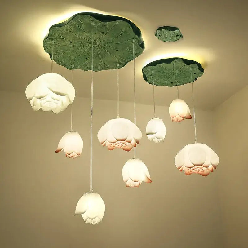 DecorBites lotus glass pendant lamp with delicate white ceramic lotus flower and soft pink accents on green leaf fixture