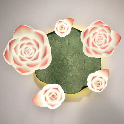 DecorBites lotus glass pendant lamp features a green lotus leaf with four glowing pink and white rose-shaped glass lamps