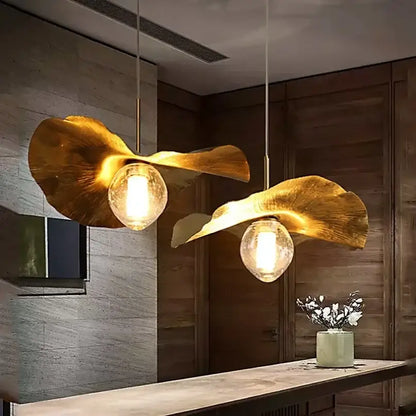 Golden leaf-shaped pendant lamp with warm glow clear glass bulbs decorbites lotus leaf brass for minimalist rooms