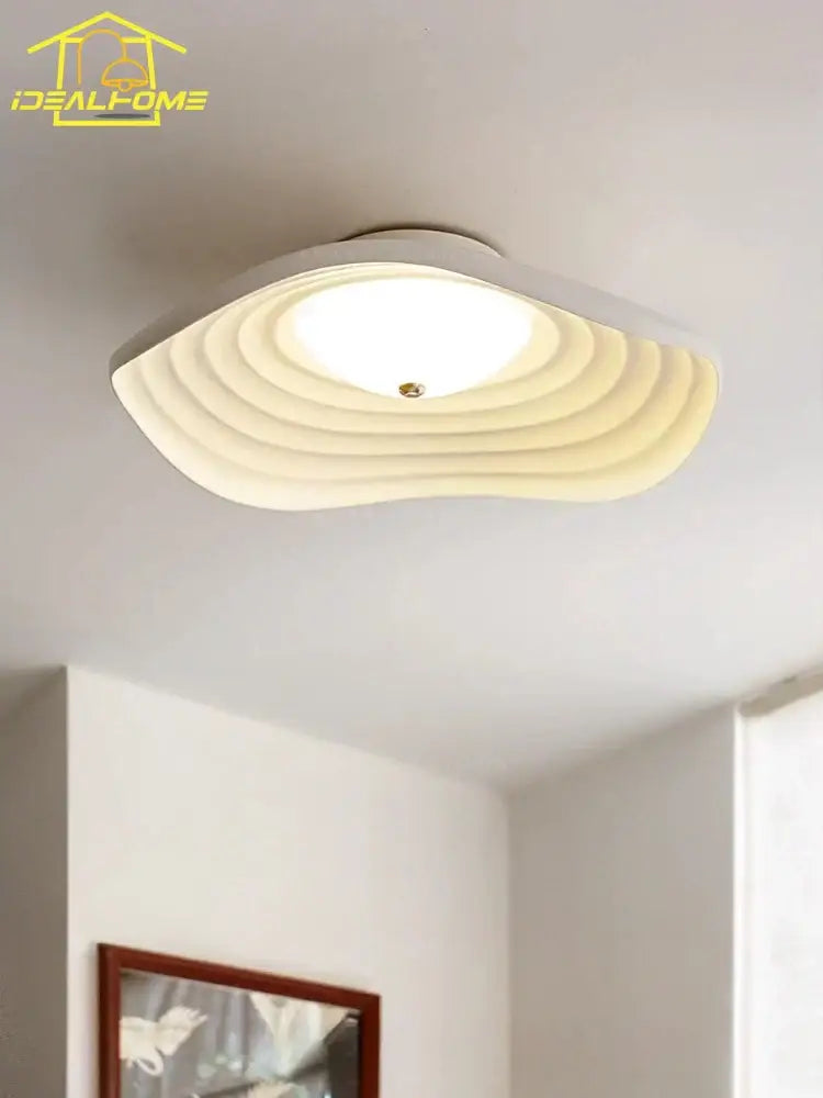 Decorbites lotus leaf ceiling light is a modern white resin ceiling light with concentric ripple ridges and soft glowing center