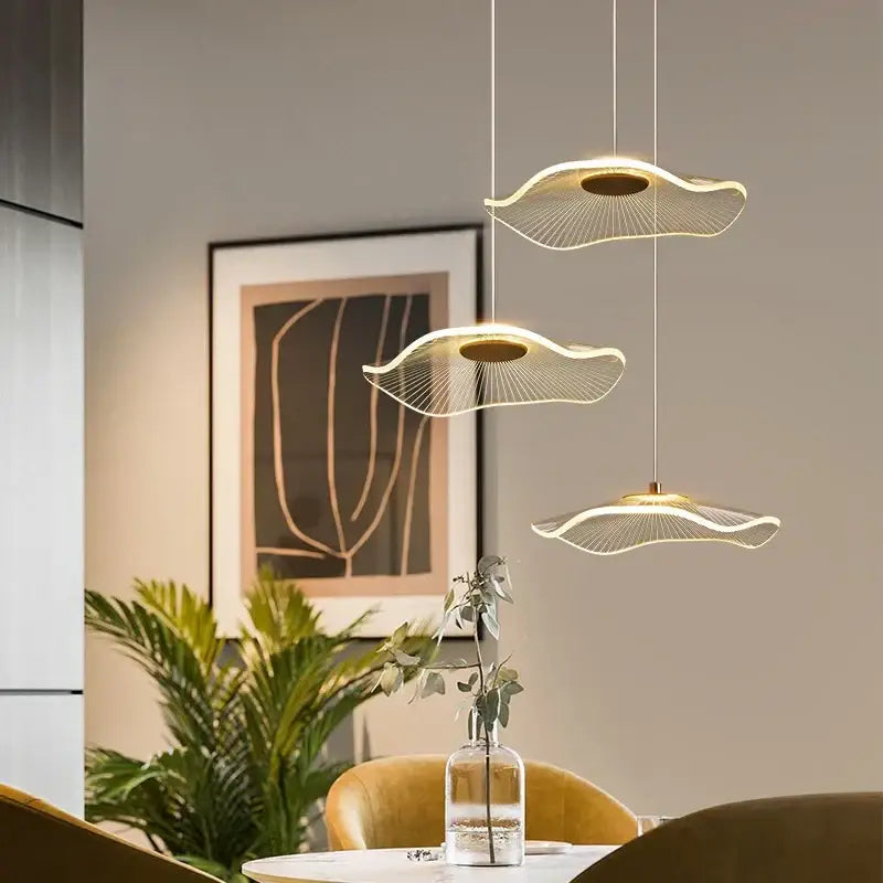 Three modern decorbites lotus leaf chandelier pendant lights with wave-shaped metallic wire design and warm led lighting