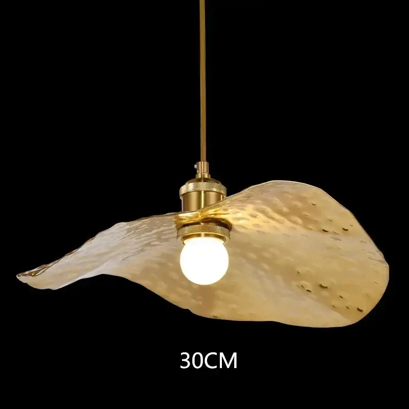 A golden hammered metal decorbites lotus leaf led pendant light with flowing leaf-like shade and brass hardware