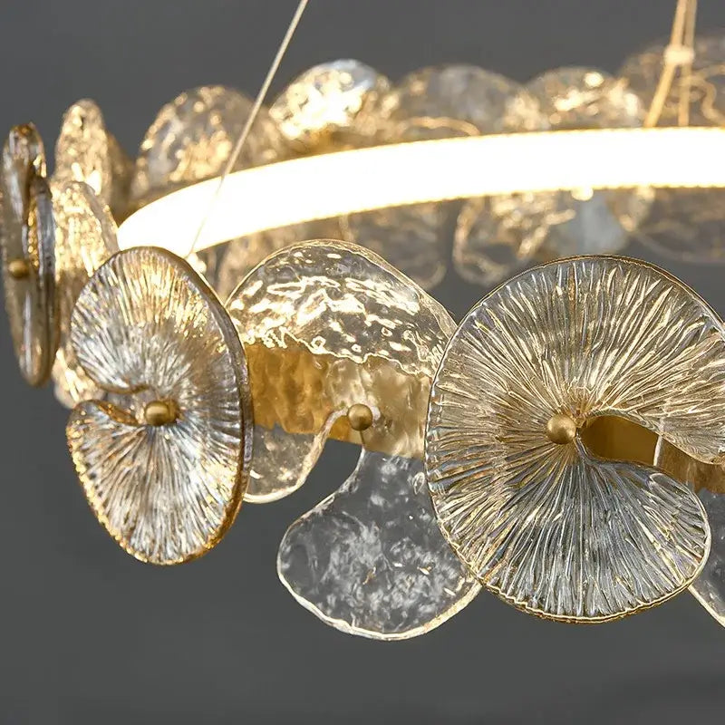 A modern decorbites lotus leaf led chandelier with translucent textured glass discs and gold metallic rims for living rooms