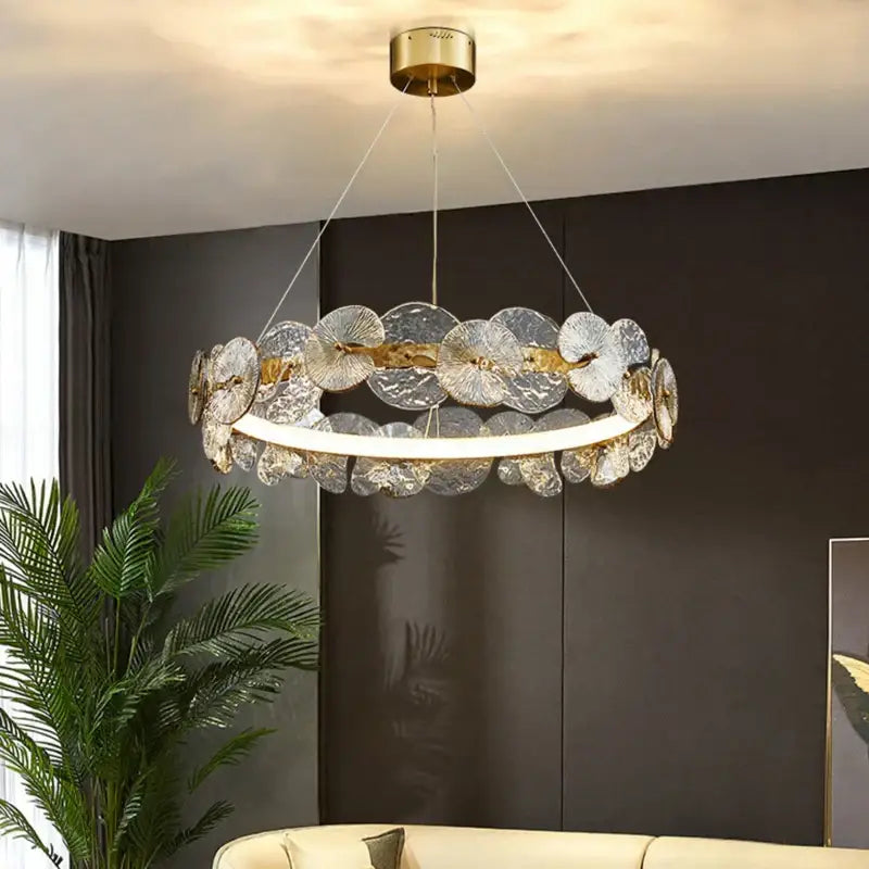 Elegant gold-toned decorbites lotus leaf LED chandelier with translucent fan-shaped glass discs for living room lighting