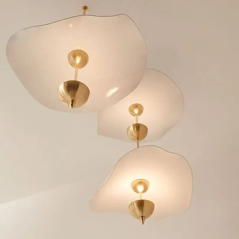 Three elegant cloud-shaped decorbites lotus leaf pendant lamps with frosted glass and polished brass fixtures for luxury decor
