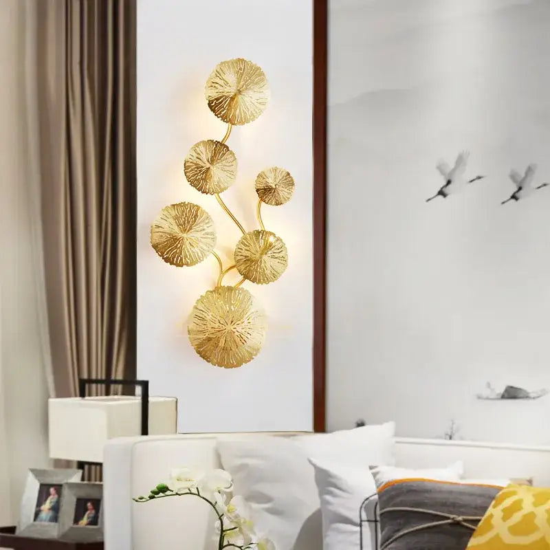Gold-toned metallic decorbites lotus leaf wall lights featuring textured circular discs for living room and bedroom decor
