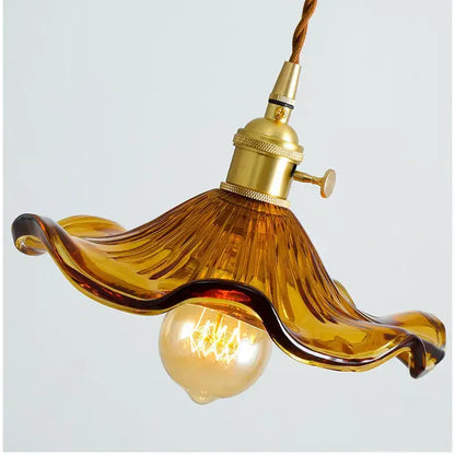 Amber-colored hand-blown glass lotus leaf pendant light with brass socket and twisted cord by decorbites lotus leaf pendant lights