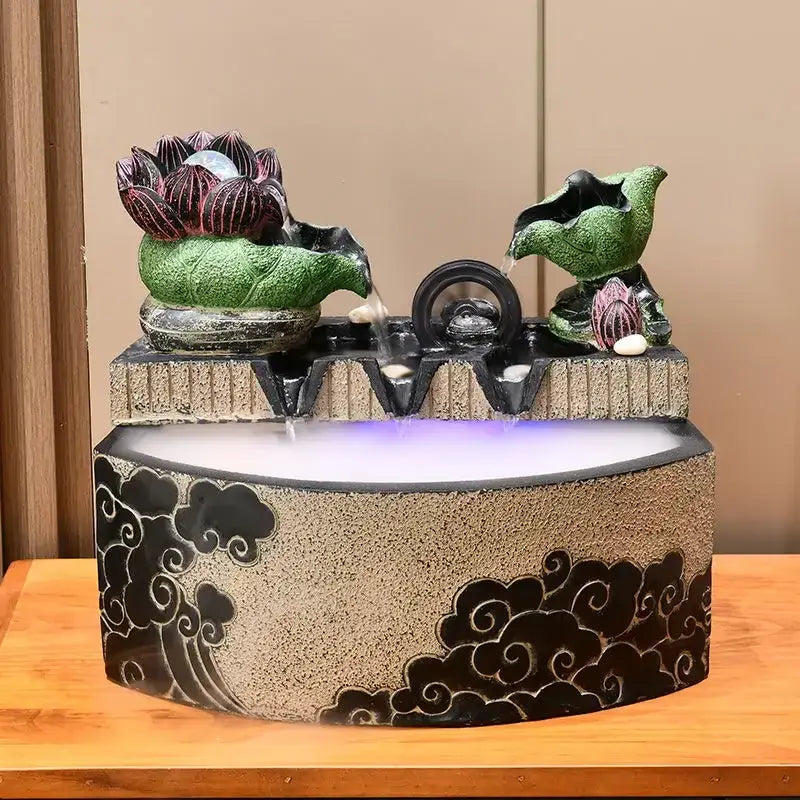 Decorbites lotus leaf water feature with green ceramic lotus figures flowing water into a beige basin with black clouds