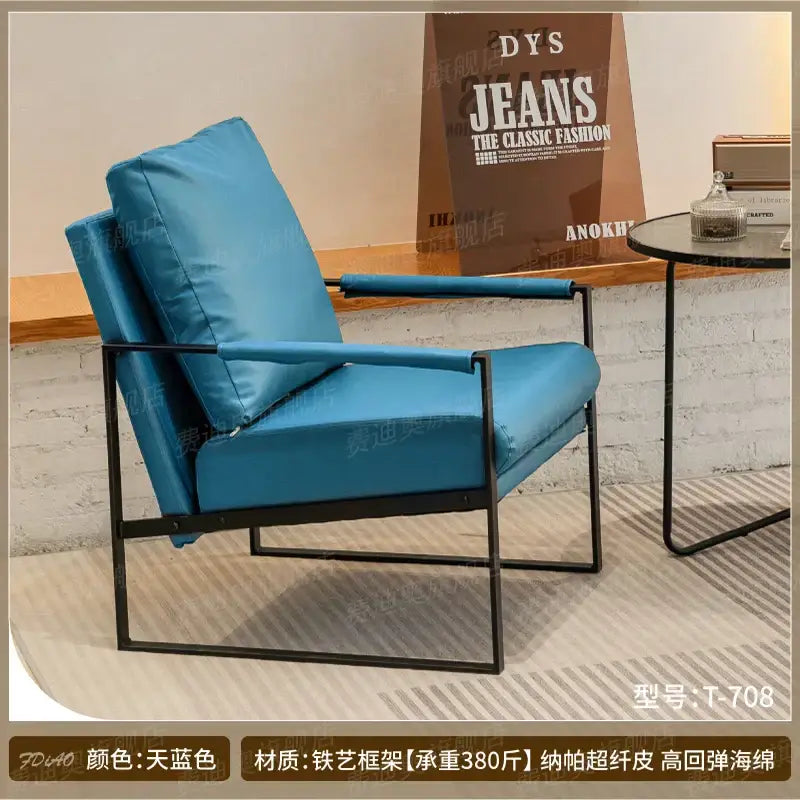A decorbites lounge chair with sleek black metal frame and plush turquoise cushions for casual comfort spaces