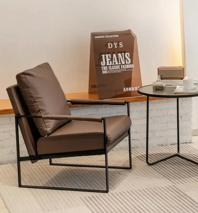 Brown leather decorbites lounge chair with sleek black metal frame for casual comfort in coffee shop or hotel balcony