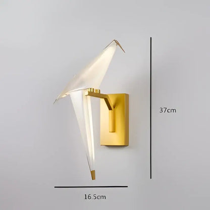 Gold-toned DecorBites™ Love Bird led wall sconce with iron and acryl body featuring translucent white glass wings