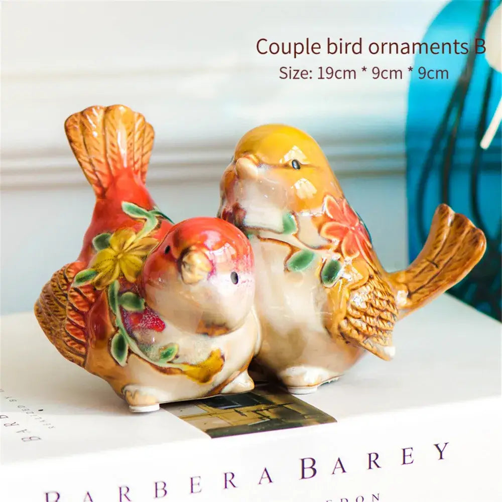 Ceramic DecorBites love birds porcelain couple ornament with hand-painted warm orange, red, and yellow floral designs