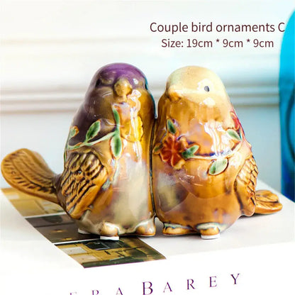 Ceramic couple bird ornaments in warm brown and purple with hand-painted floral details from decorbites love birds porcelain collection