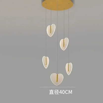 Modern pendant light fixture with five heart-shaped lamps in gold and brass by decorbites love chandelier for living room
