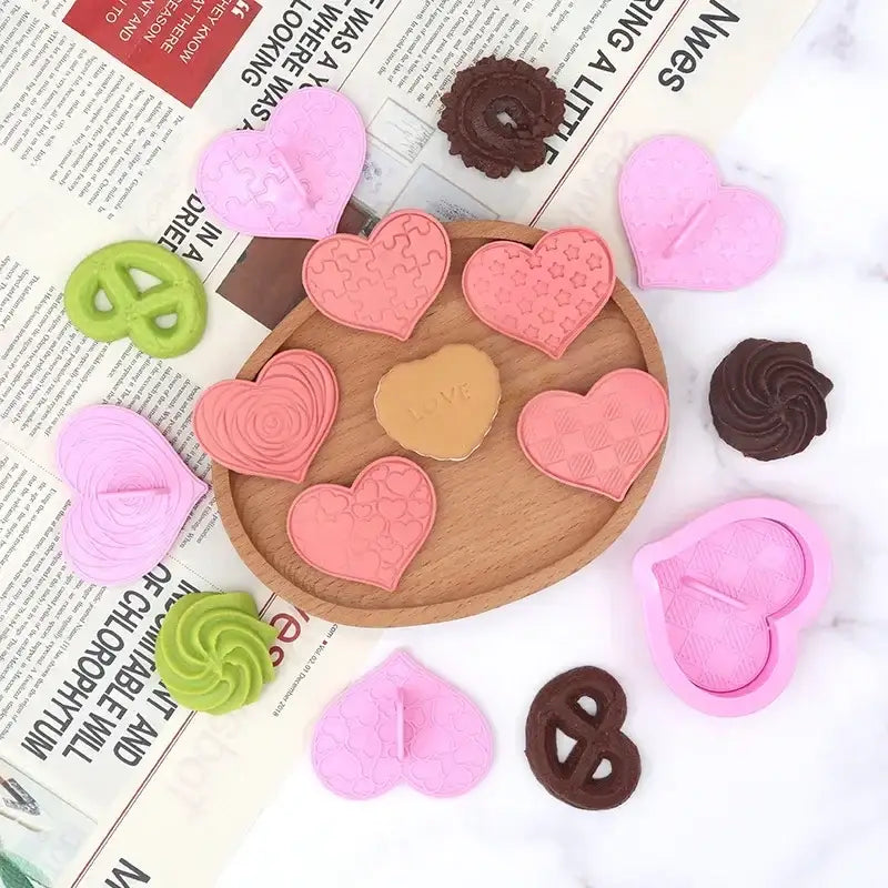 Pink heart-shaped silicone biscuit cutter with textured patterns and central cutout decorbites love heart tool