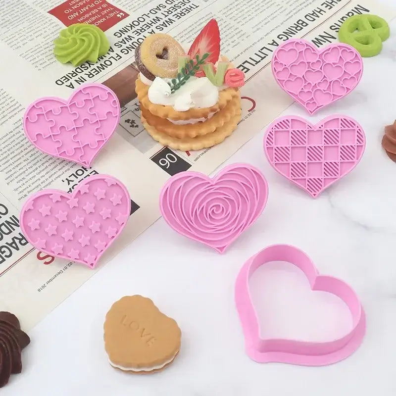 Set of pink silicone DecorBites love heart biscuit cutters with intricate designs for Valentine’s Day cake decorating