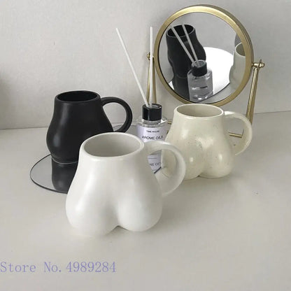 White ceramic coffee cup with playful butt shape design and glossy finish for decor and storage by decorbites