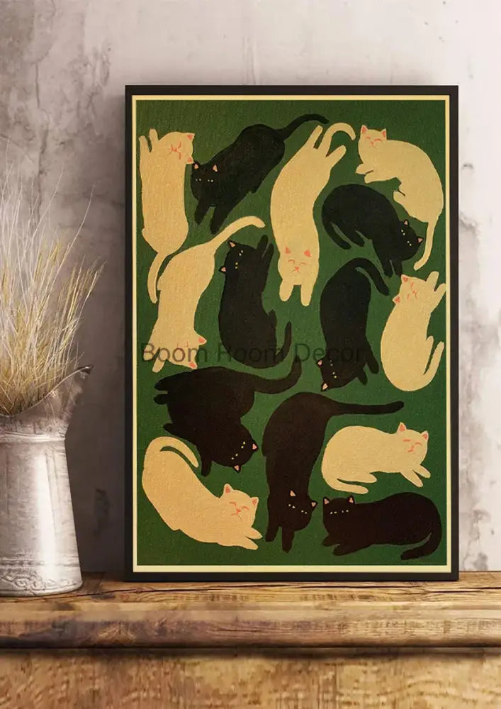 A framed DecorBites™ cat paper poster with black and cream stylized cats on a deep green background for home decor
