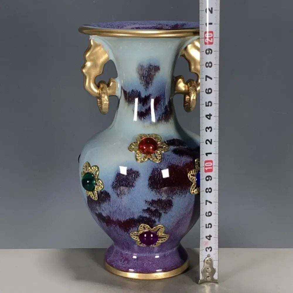 A decorative qinzhai jun porcelain bottle ornament with blue to purple glaze gold handles and gem-inlaid floral accents