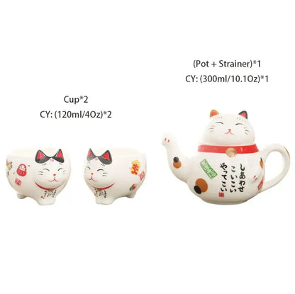 White ceramic teapot shaped like a smiling cat with red collar black accents japanese characters and orange polka dots from decorbites lucky cat porcelain tea set