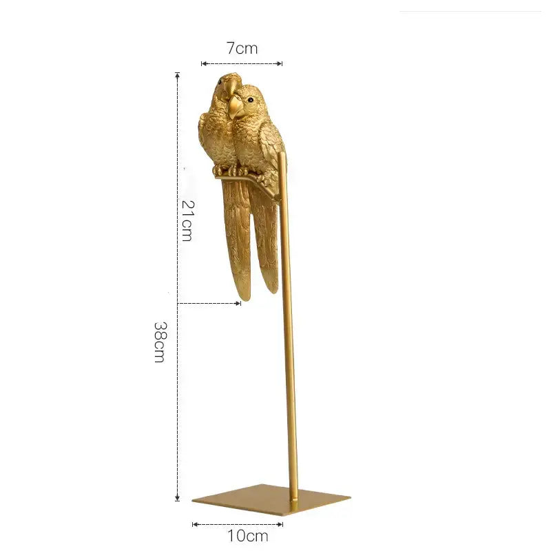 Golden metallic decorbites lucky parrot resin ornament featuring two parrots perched on a slender stand