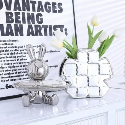 Silver decorbites lucky rabbit key tray and matching cross vase with reflective metallic surfaces and intricate details