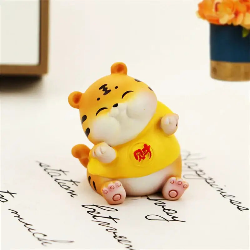 DecorBites™ lucky tiger figurine in yellow with black stripes pink paws and red Chinese character shirt for home decor
