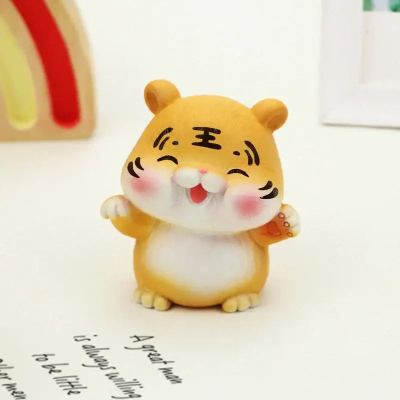 Cute yellow lucky tiger figurine with white belly and pink cheeks featuring a smiling face and chinese characters