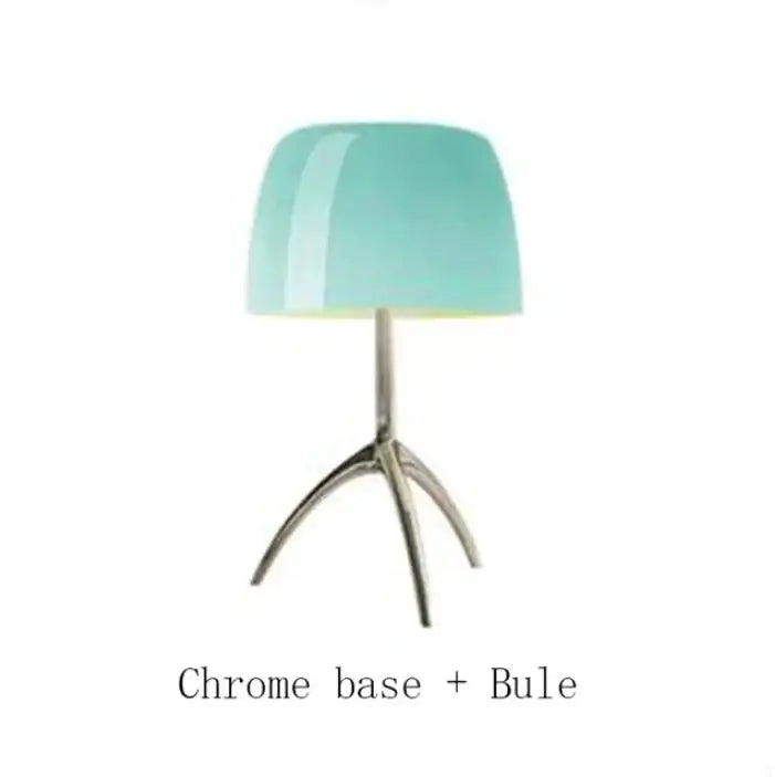 A decorbites lumiere glass table lamp with a glossy teal glass shade and polished chrome tripod base for modern decor
